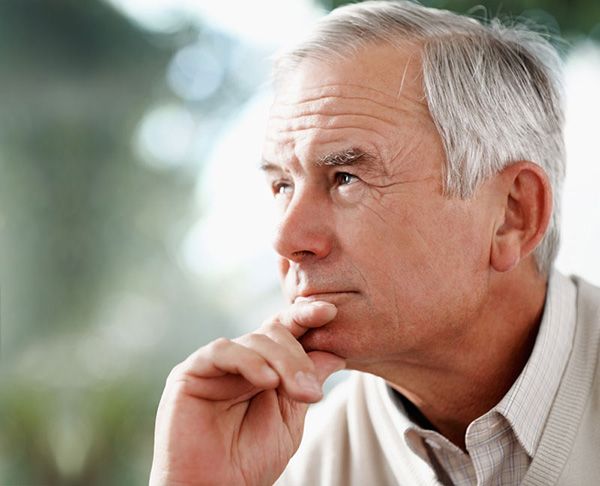 hearing_loss_dementia older man looks off into the distance with hand on chin