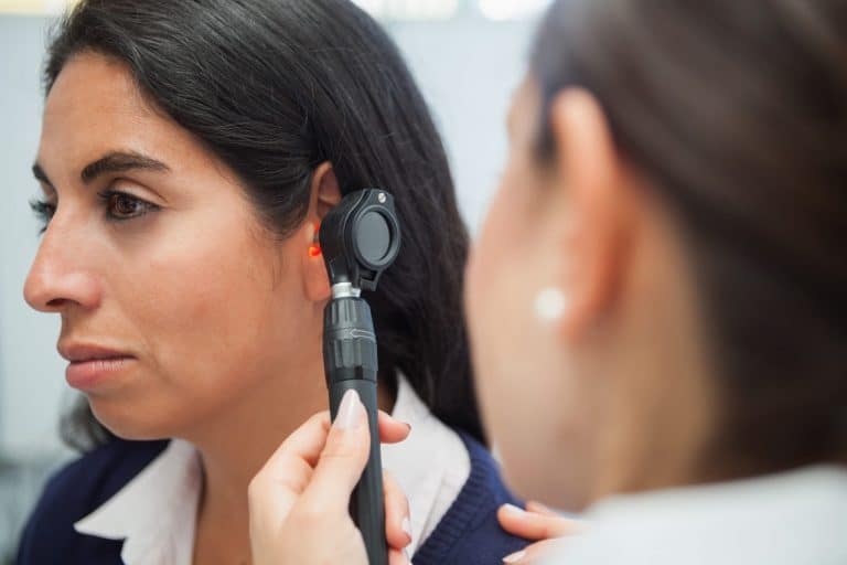 What to Know Before Your First Audiologist Visit Woman getting her ears checked by an audiologist