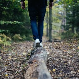 Hiker balancing on a log