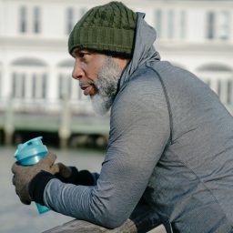 Man thoughtfully looking out across river.