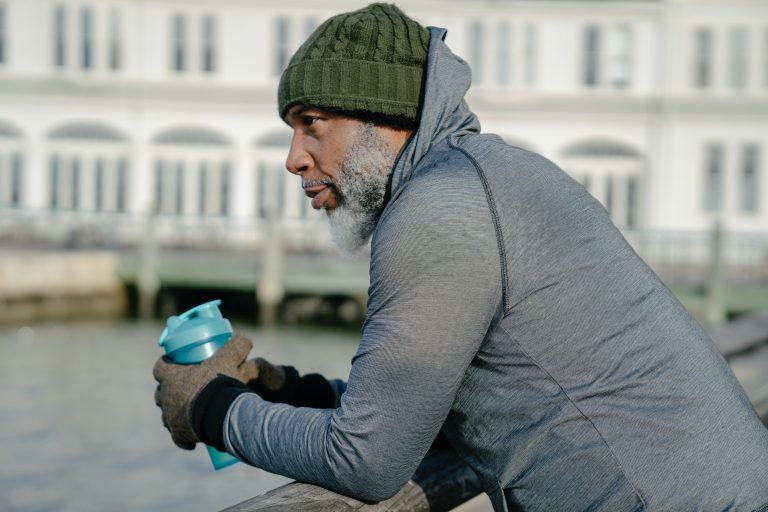 thoughtful man-hearing aids-when to wear Man thoughtfully looking out across river.