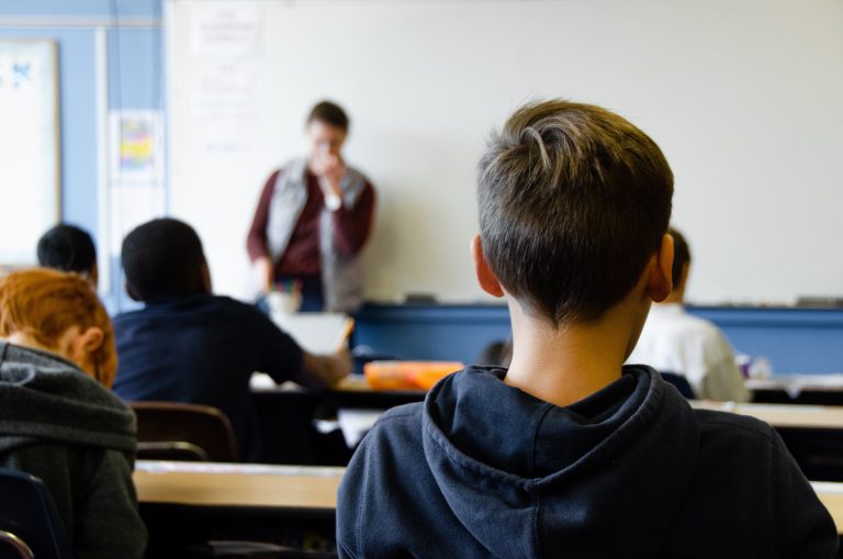 A teacher and students in a classroom.