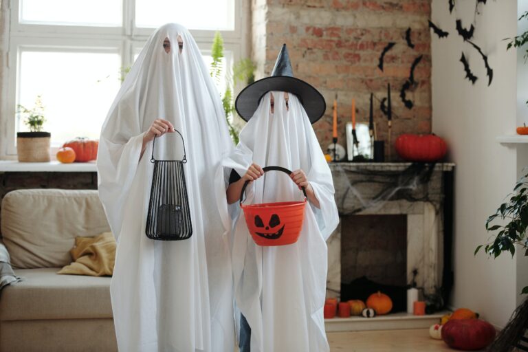 halloween-costumes-ghost-hearing protection Parent and child dressed as ghosts for Halloween.
