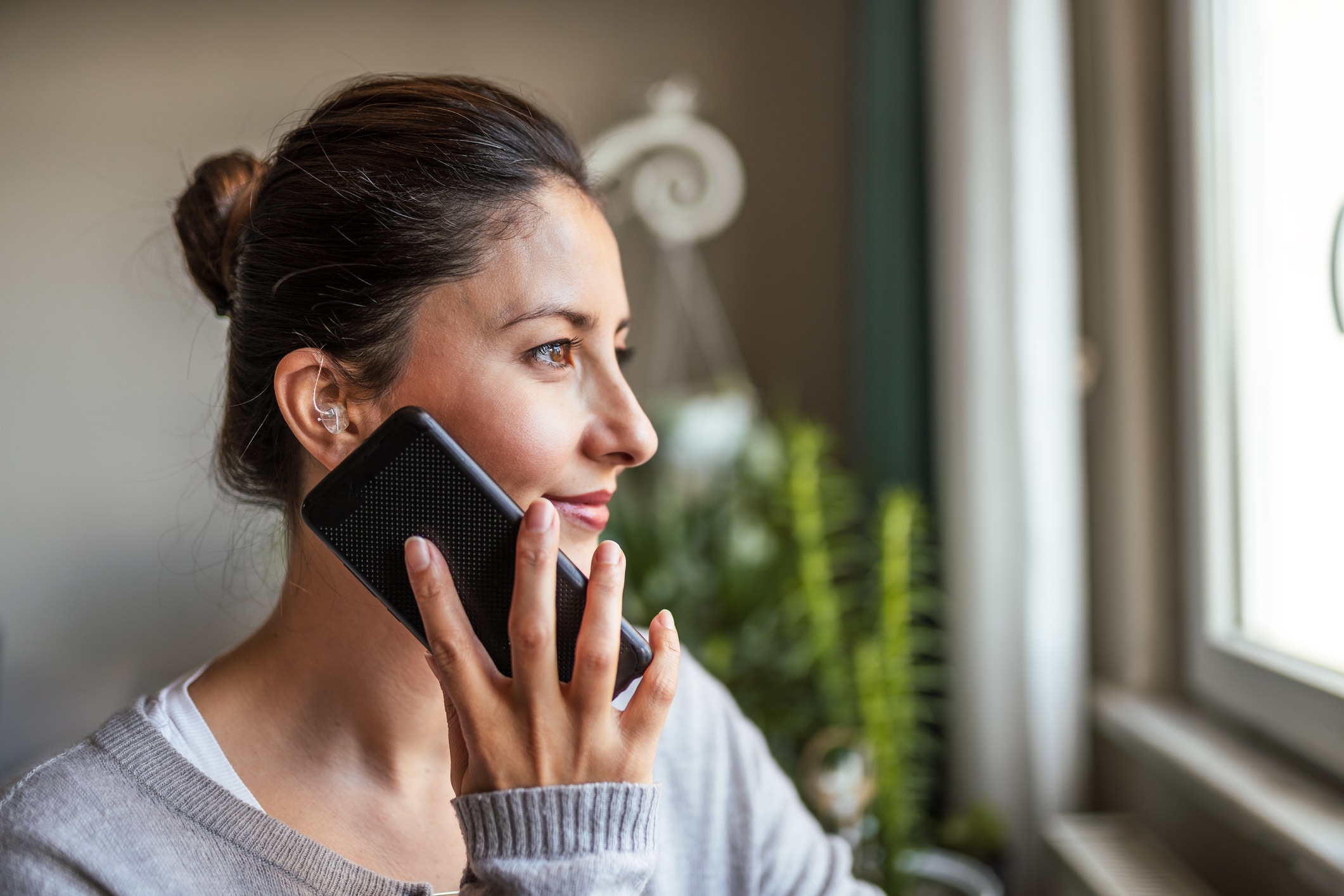 woman on the phone with a hearing aid