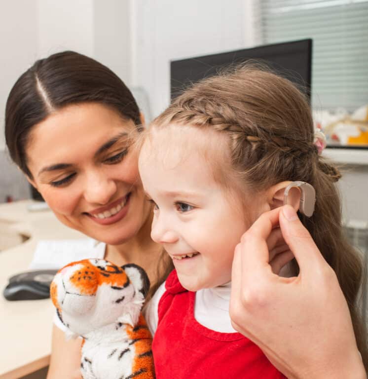 Pediatric Hearing Aid Young girl looking happy getting her first hearing aid
