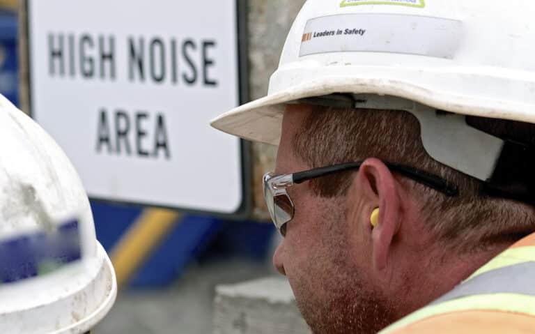 Construction worker wears ear plug Construction worker wears ear plug