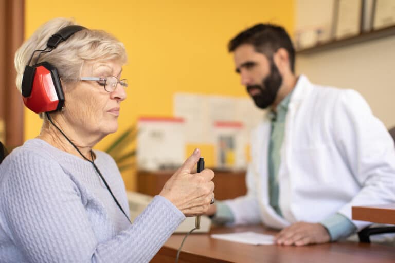 Pure Tone Hearing Test Senior woman taking a pure tone hearing test
